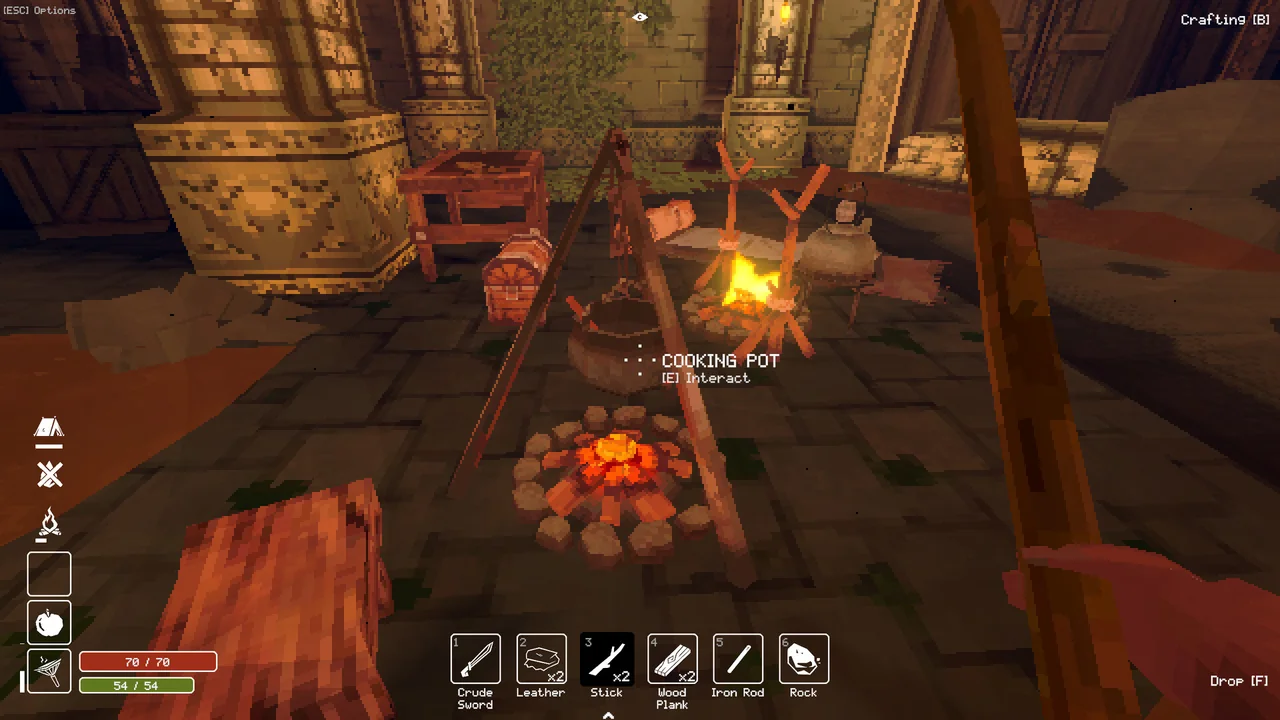A cooking fire and pot at a stone dungeon camp